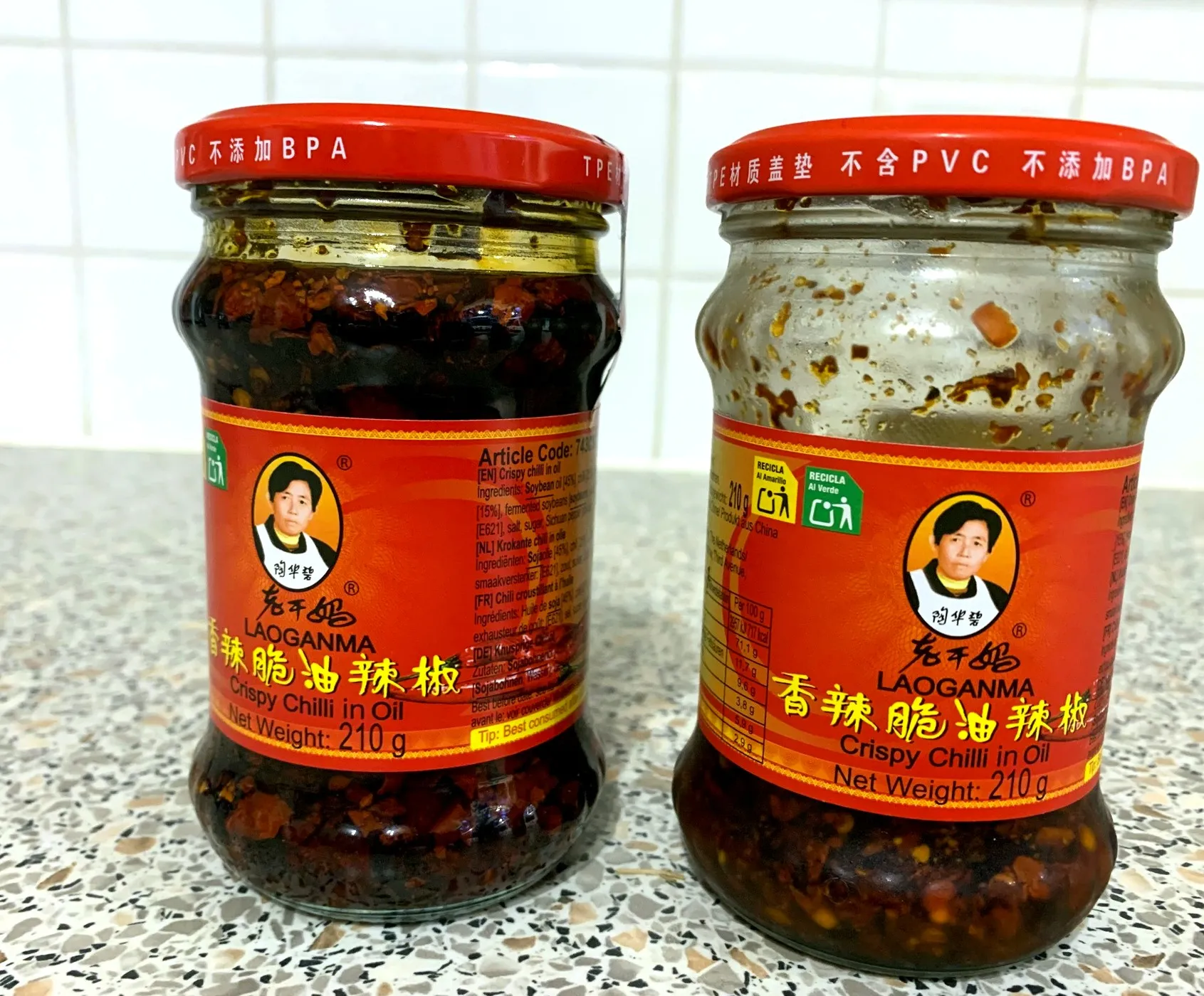 Two jars of Lao Gan Ma crispy chilli oil, one full and one nearly empty