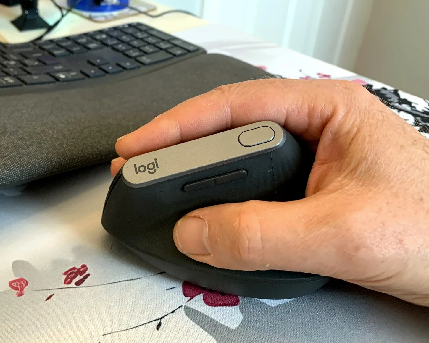 Large hand resting naturally on a Logitech MX Vertical mouse